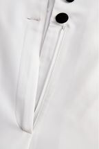 Sleek White Jumpsuit With Dual Button Detail And Black Lapel