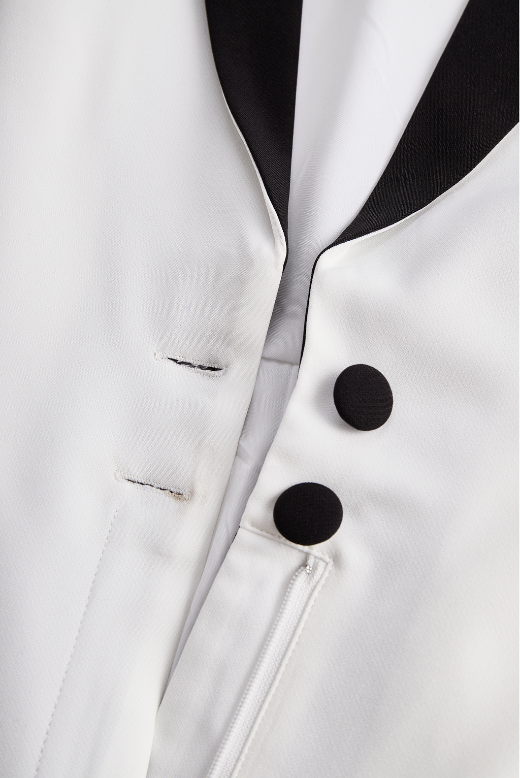 Sleek White Jumpsuit With Dual Button Detail And Black Lapel