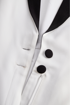 Sleek White Jumpsuit With Dual Button Detail And Black Lapel