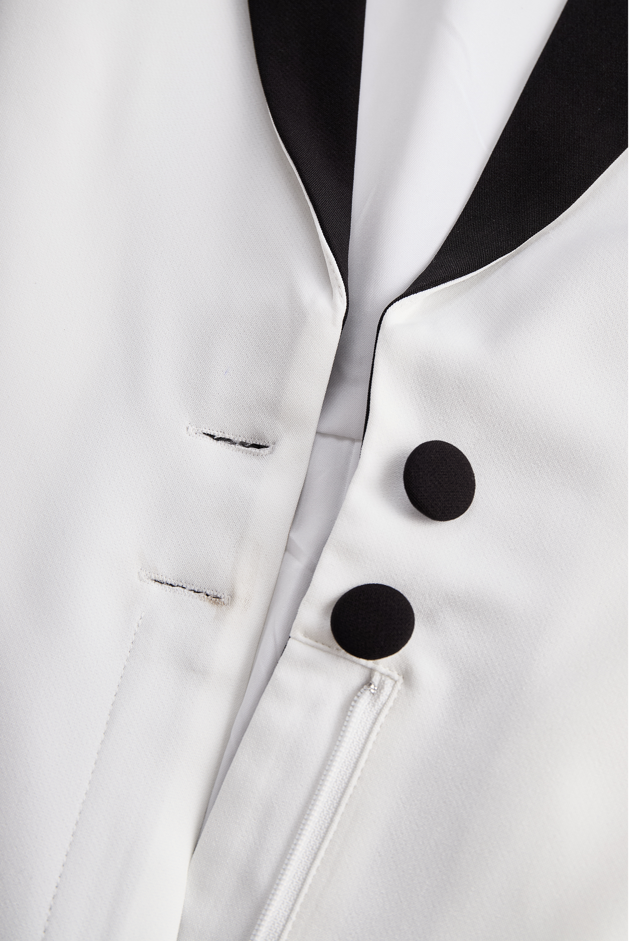 Sleek White Jumpsuit With Dual Button Detail And Black Lapel