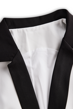 Sleek White Jumpsuit With Dual Button Detail And Black Lapel