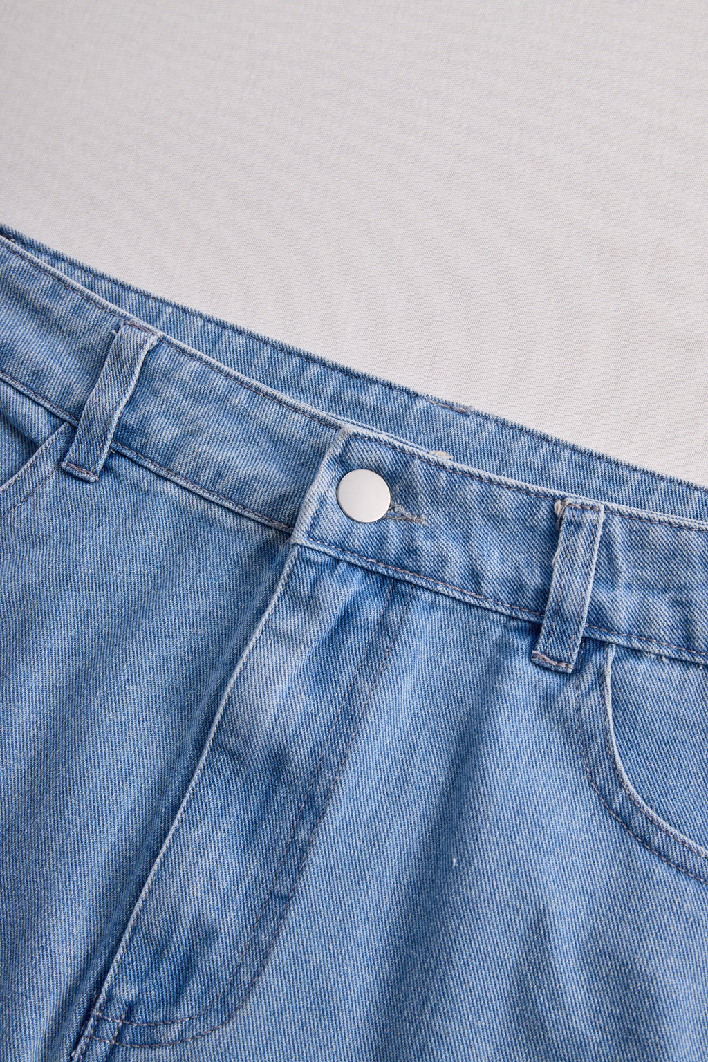 Stylish Denim Two-Piece Set With Asymmetrical Top And Fringed Skirt