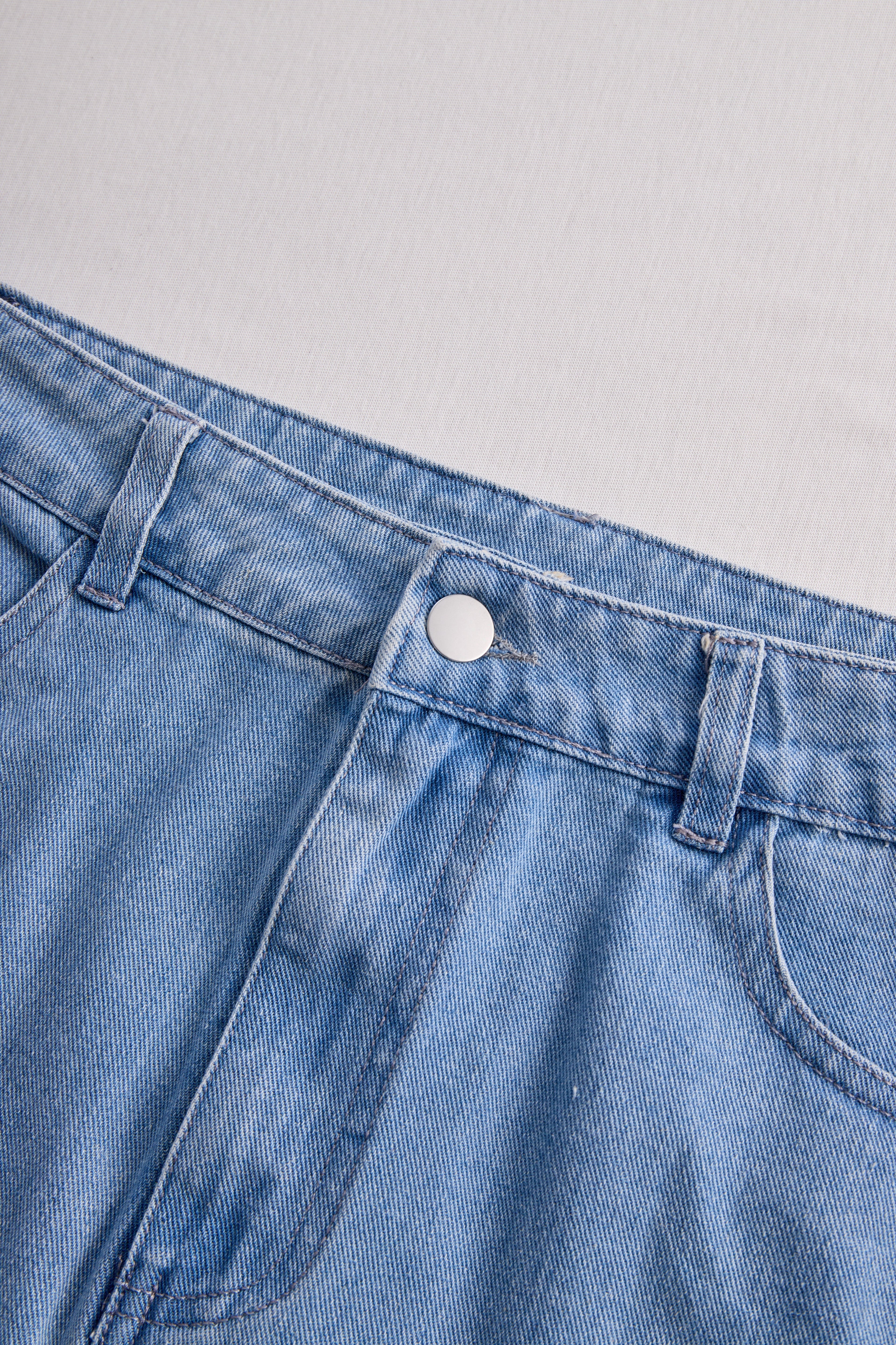 Stylish Denim Two-Piece Set With Asymmetrical Top And Fringed Skirt